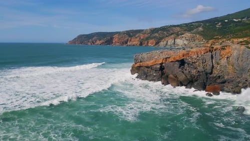 Sea Hitting Rugged Coastal Cliffs Sunny Day Rough Ocean Waves Rolling to Rocks