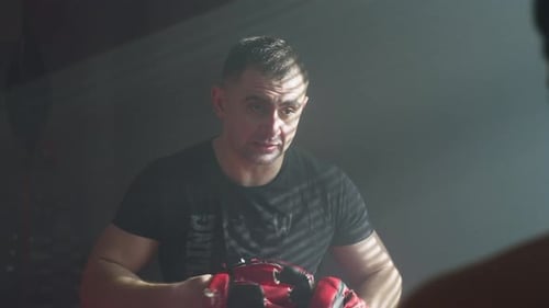 Boxing Trainer Working with Boxer in Gym