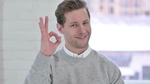 Young Adult Gives Ok Sign with Smiling Face