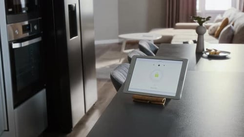 Adult Using Tablet Security App in Modern Home