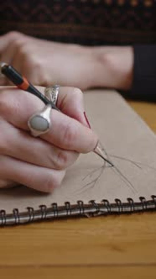 Vertical of Faceless Woman Drawing Pencil Landscape Painting at Table