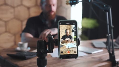 Content Creator Recording with Phone on Tripod