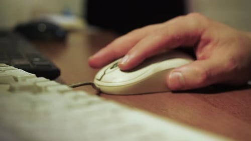 Hand Using Computer Mouse at Desk