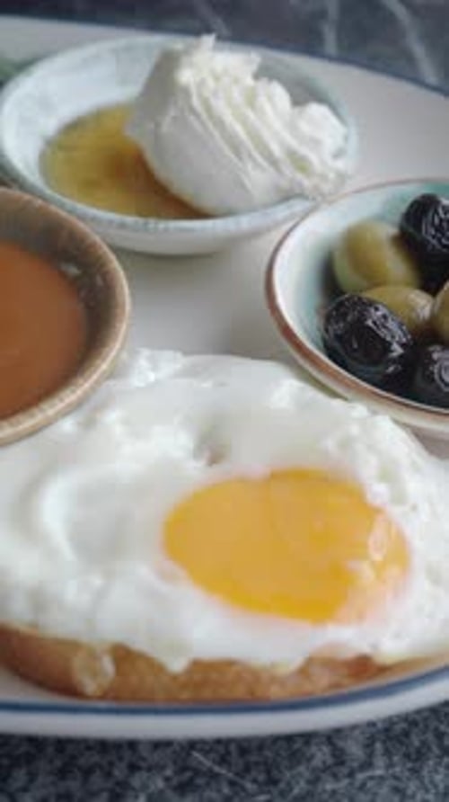 Breakfast Spread with Eggs Olives and Honey