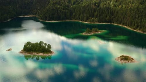 Small Island with Trees in the Middle of the Lake with Transparent Water