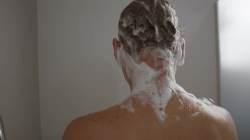 Man Washing Hair with Shampoo in Shower