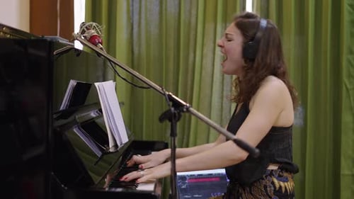 Woman Plays Piano and Sings with Emotion
