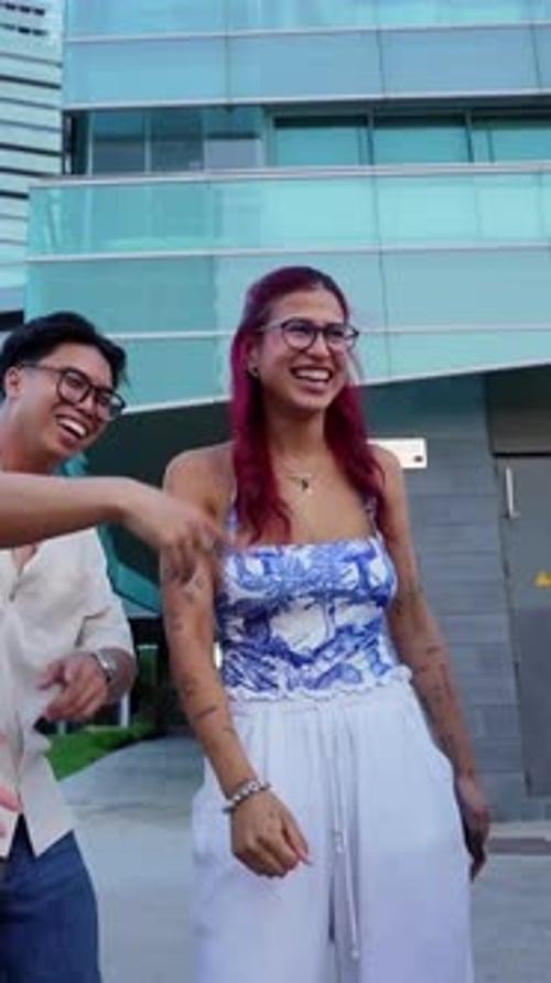 Happy Young Friends Dancing Together in the Middle of the City