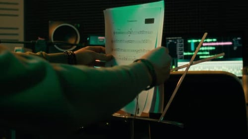 Faceless Musician Putting Music Sheets on Stand in Recording Studio