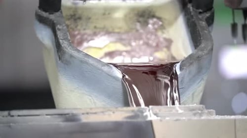 Molten Metal Flows from Crucible in Factory