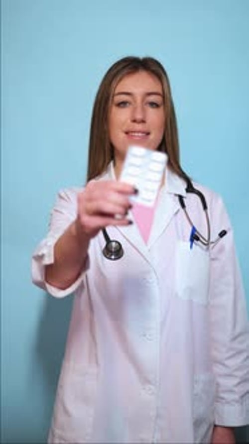 Young Doctor Holding Pills in Blister Pack