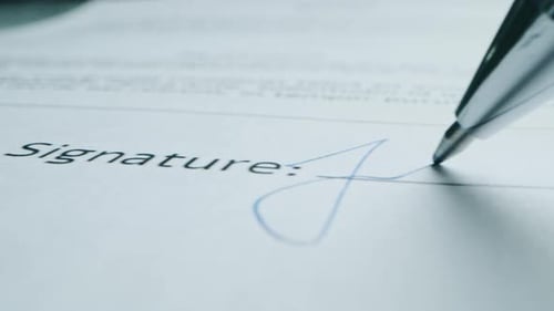Signing a Document with a Pen Close Up