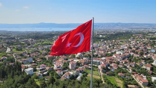 Aerial View: Turkish Flag Waves Over Urban Landscape