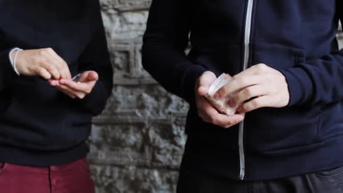 Addict buying drug dose from dealer on street crime and addiction concept