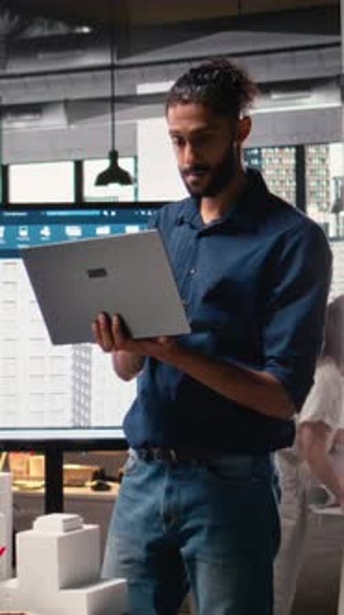 Vertical Video Male Real Estate Engineer Studying Smart City Design and Buildings Layout