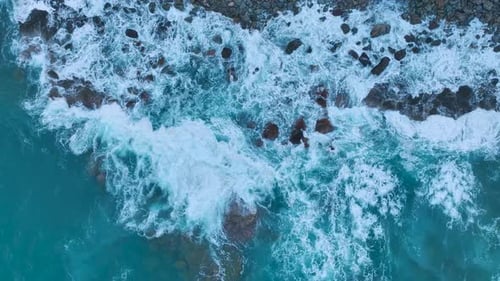 Aerial View Stormy Sea Clashing With Rocks at Dawn Creating Dramatic Sea Texture