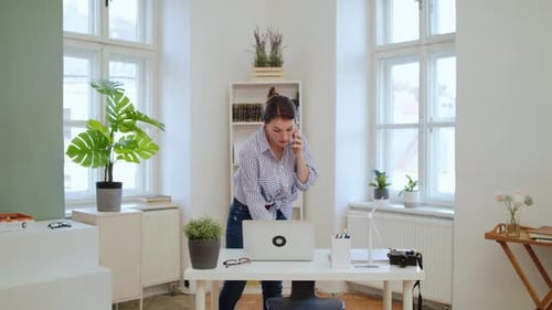 Businesswoman works from home with laptop and smartphone during coronavirus quarantine