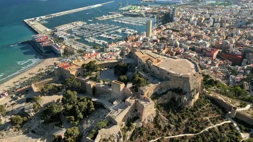 Aerial drone view of the Santa Barbara Castle on the coast of Alicante, Spain with the city and the