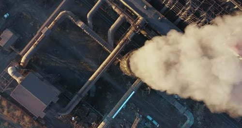 Aerial View of Industrial Plant Releasing Plumes of Smoke