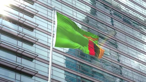 Zambia Flag Waving in Front of Modern Corporate Building
