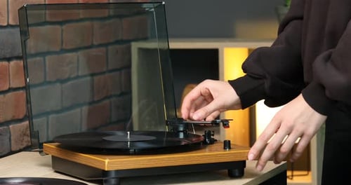 Close-up of person using record player