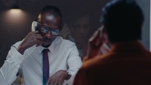 Detective Showing Mugshots and Speaking with Prisoner in Visiting Room