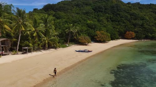 Aerial perspective of Coco Beach, showcasing its tranquil beauty and vibrant turquoise waters.