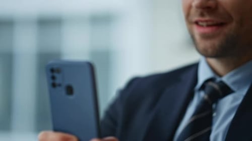 Smiling Businessman Messaging Cellphone in Office Closeup Manager Hands Texting