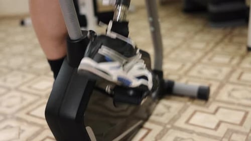 Person Using Exercise Bike with Prosthetic Leg