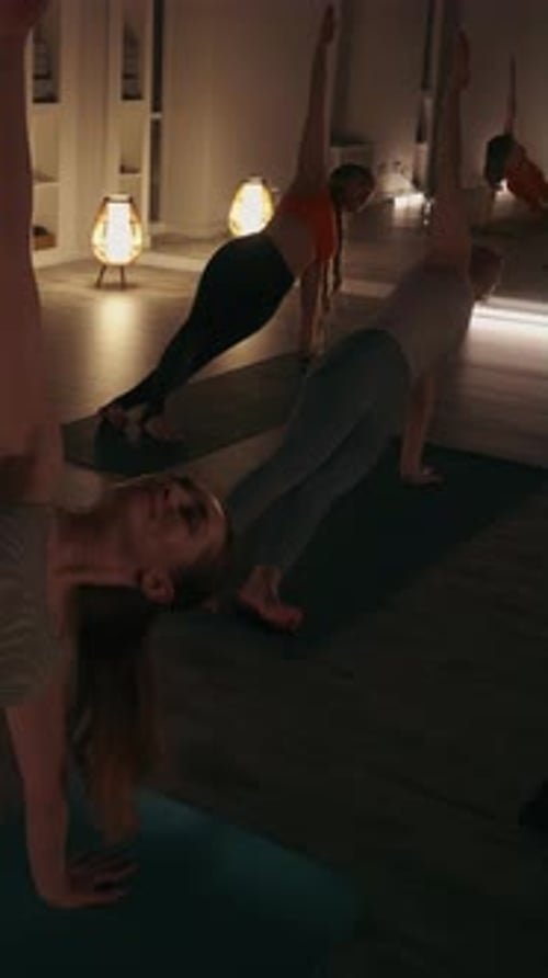 Women Practicing Yoga Positions in Relaxing Class