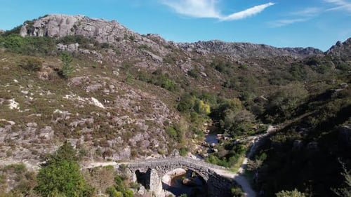Flying Over Ancient Stone Bridge Over Beautiful River. Amazing Nature Landscape