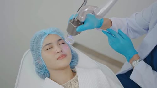 Asian Doctor doing laser on the woman face at beauty clinic. woman having facial skin care treatment
