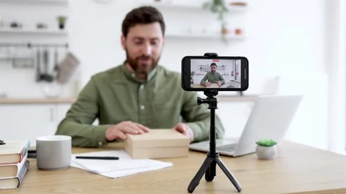 Vlogger Unpacking Joystick During Live Stream at Home