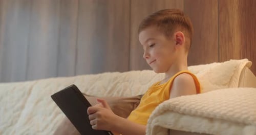 Close Up Boy 78 Years Afraid Child Using Tablet in Living Room Small Child Hold Pad Computer Surfing