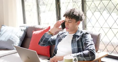 Young Man Working from Home on Laptop