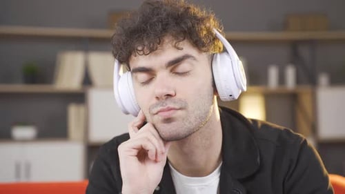 Depressed young man listening to music.
