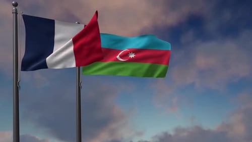 Flags of France and Azerbaijan Waving Against a Cloudy Sky