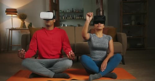 Couple Exercising at Home With Virtual Reality Headsets