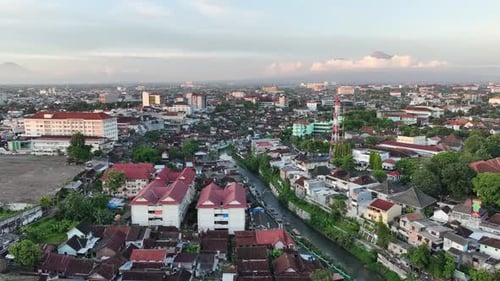 Aerial view of housing in Yogyakarta city at sunset with view of Mount Merapi, Indonesia.