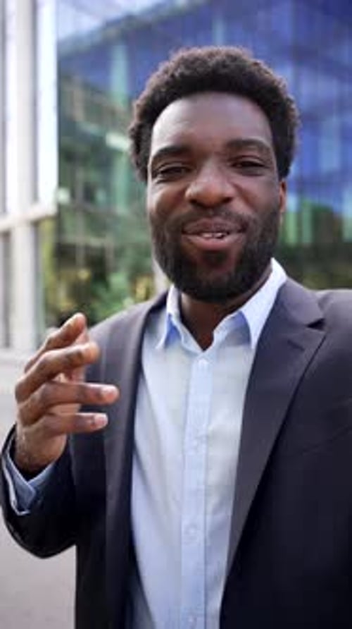 Happy Young Man Talking in Urban Business Setting