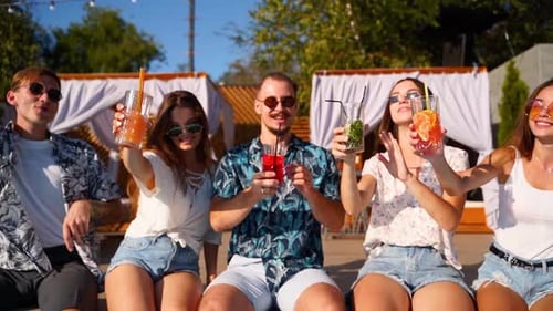 Friends Toasting Cocktails at Poolside Party