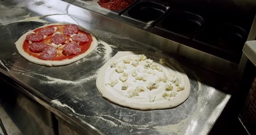 Chef Cook Preparing Pizza at Restaurant Kitchen and Sprinkle Parmesan Cheese