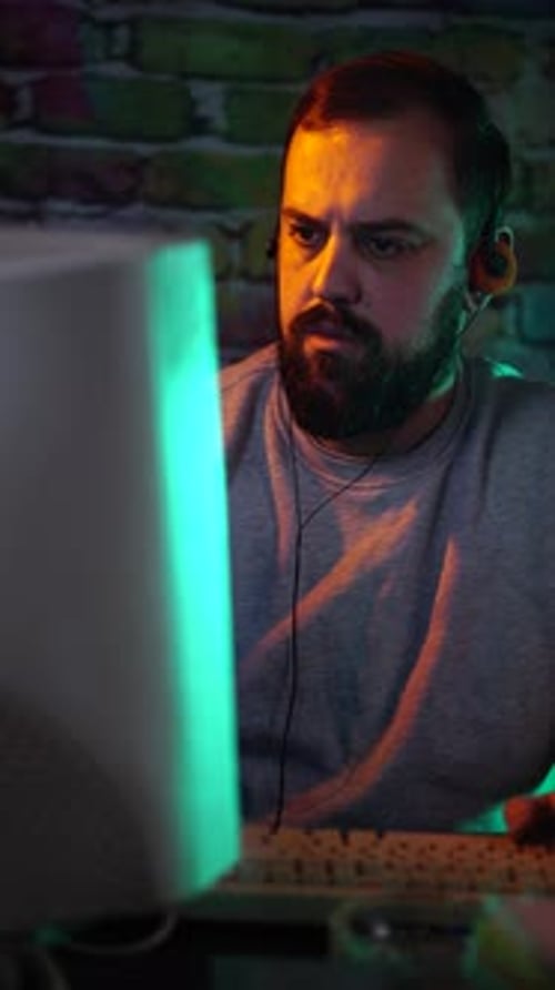 Vertical View, Man With Vintage Headphones Working on Desktop Computer From 1990's, Close Up