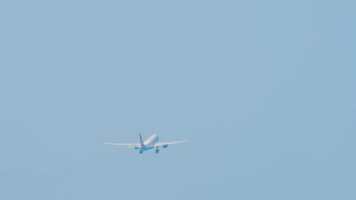 Airplane Flying in Blue Sky