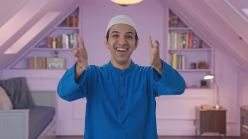 Happy Muslim man laughing on camera