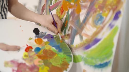 Art Therapy in Psychology Closeup View of Paintbrush in Artist Hand and Canvas Painter Applying