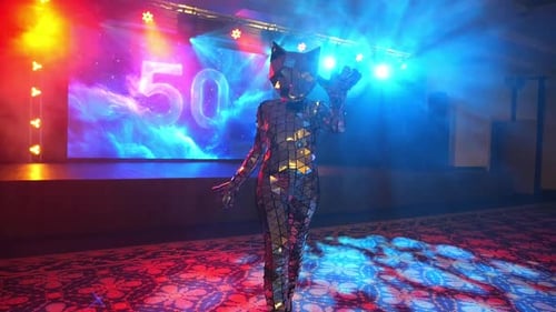 A Woman in a Silver Mirrored Tiger and Cat Costume Dances in an Empty Restaurant