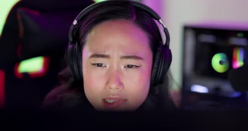 Woman Concentrating While Gaming at Computer