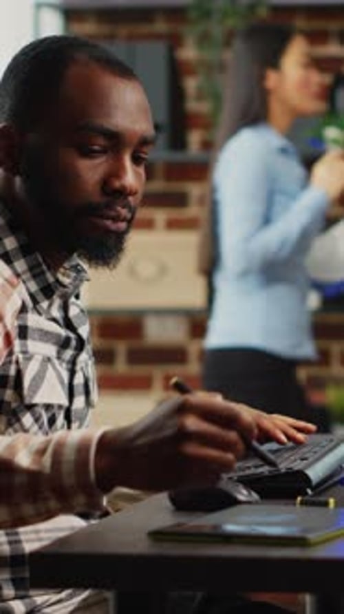 Man Working on Graphics Tablet in Office