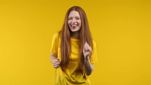 Happy Woman Dancing on Yellow Background